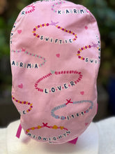 Load image into Gallery viewer, Pink Friendship Bracelet Ponytail Scrub Cap
